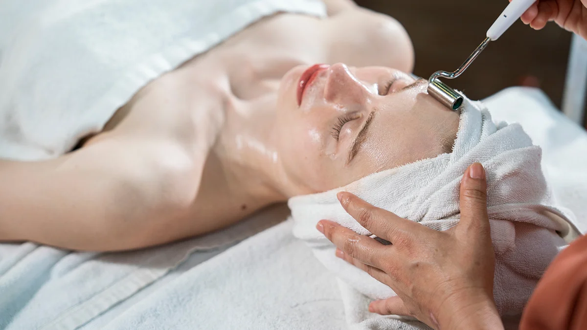 A woman having microcurrent therapy at a spa