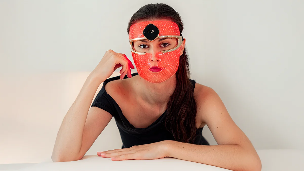 FAQ 202 red light therapy facial mask on a beautiful dark-haired woman