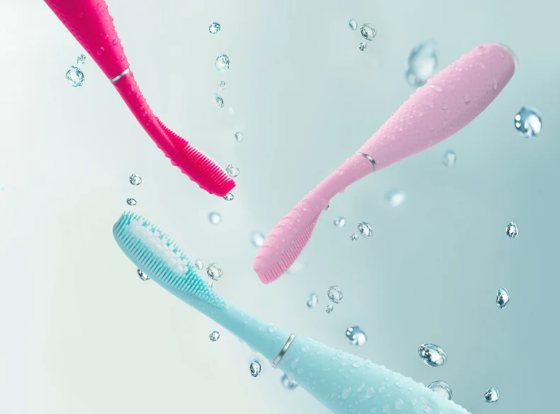 FOREO issa 4 toothbrushes in pink, red and mint with water droplets