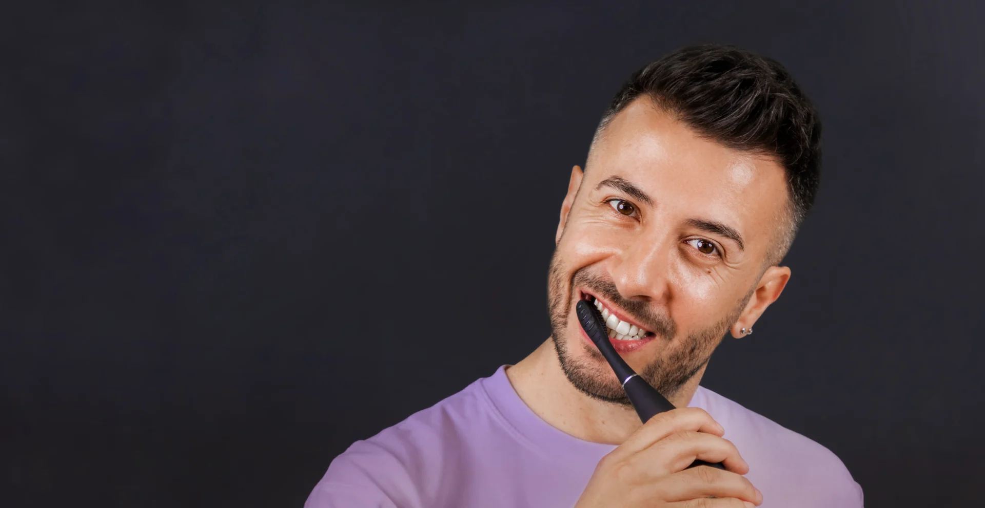 Smiling man brushing his teeth with a FOREO issa 4 plus toothbrush