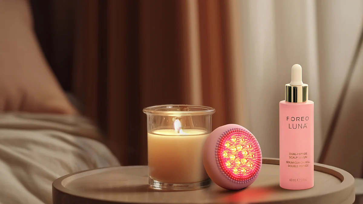 Luna Dual-Peptide Scalp Serum luna 4 hair device in a cozy room with lit candles
