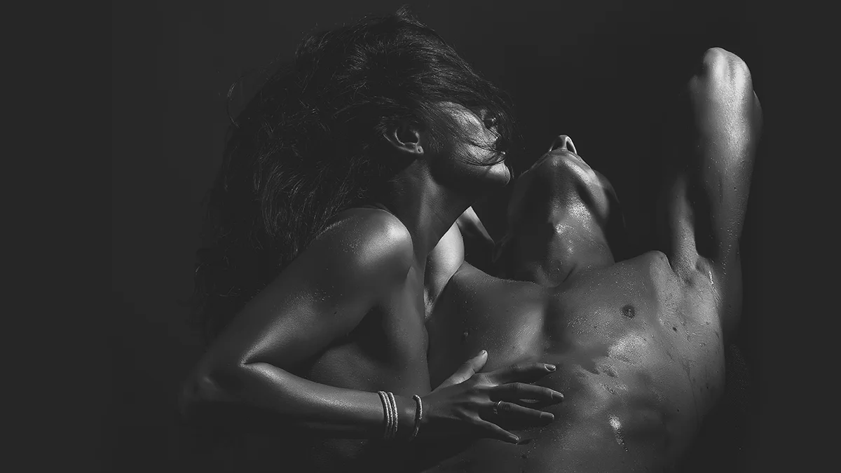 Black nad white picture of a gorgeous woman and a man engaging in foreplay