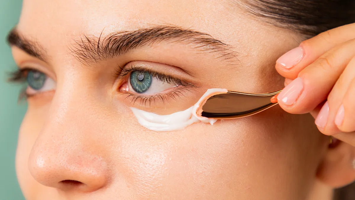 A woman using brightening IRIS eye cream 