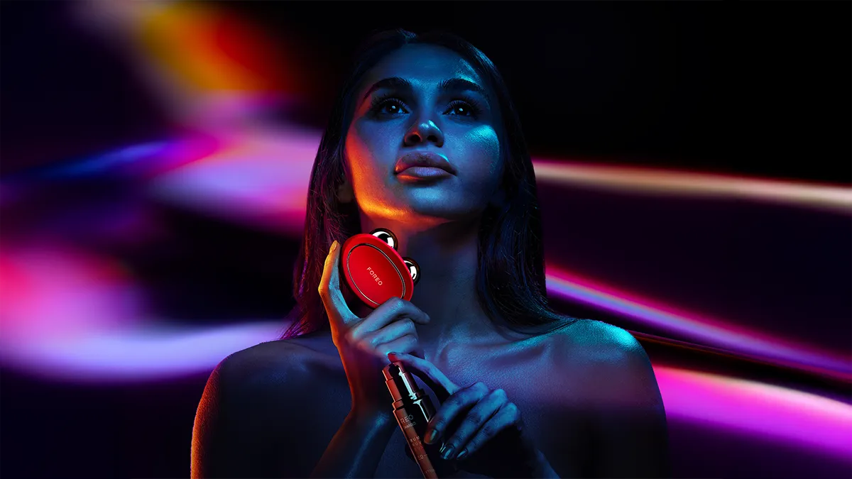 A woman using BEAR 2 microcurrent facelift device