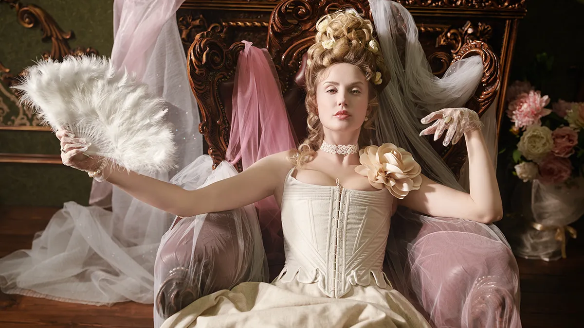 A rich woman in 18th century court with large updo hair