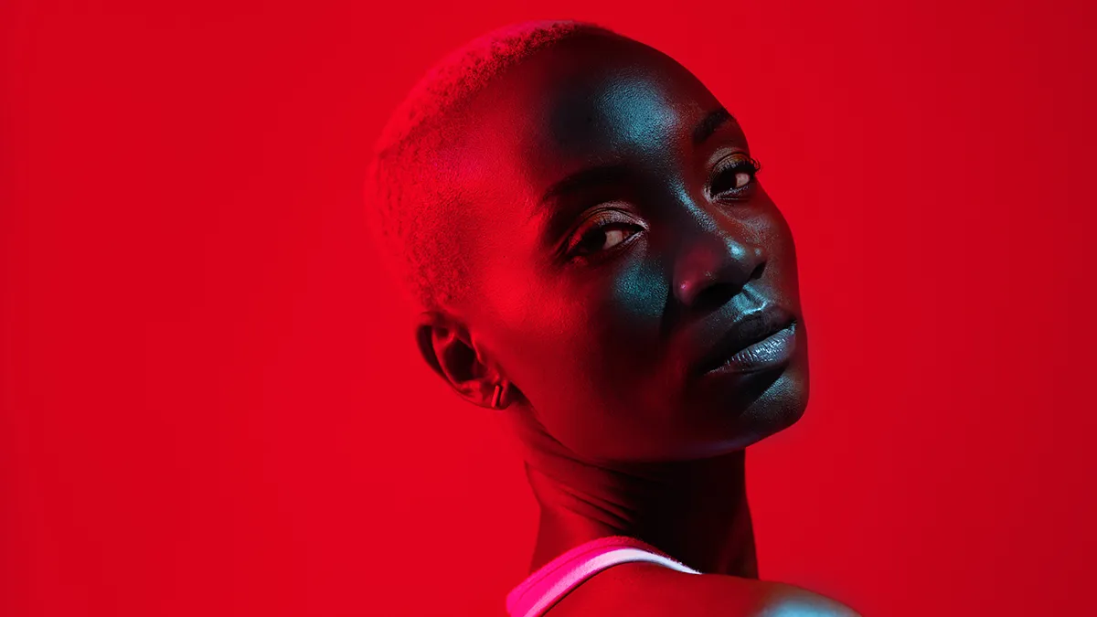 A gorgeous African-American woman in red lights