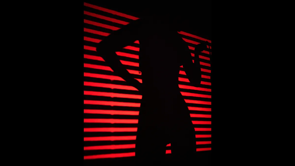 A woman shadow in red striped light