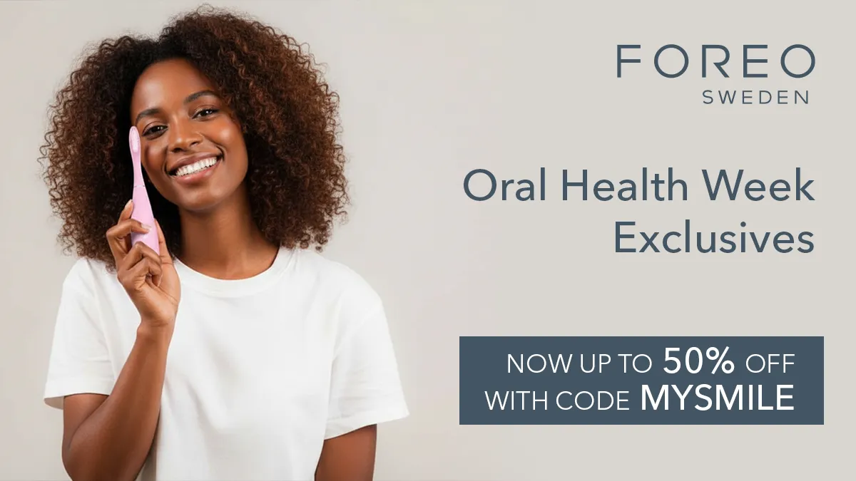 A gorgeous African-american woman in a white T-shirt using FOREO issa celebrating Oral Health Week discounts