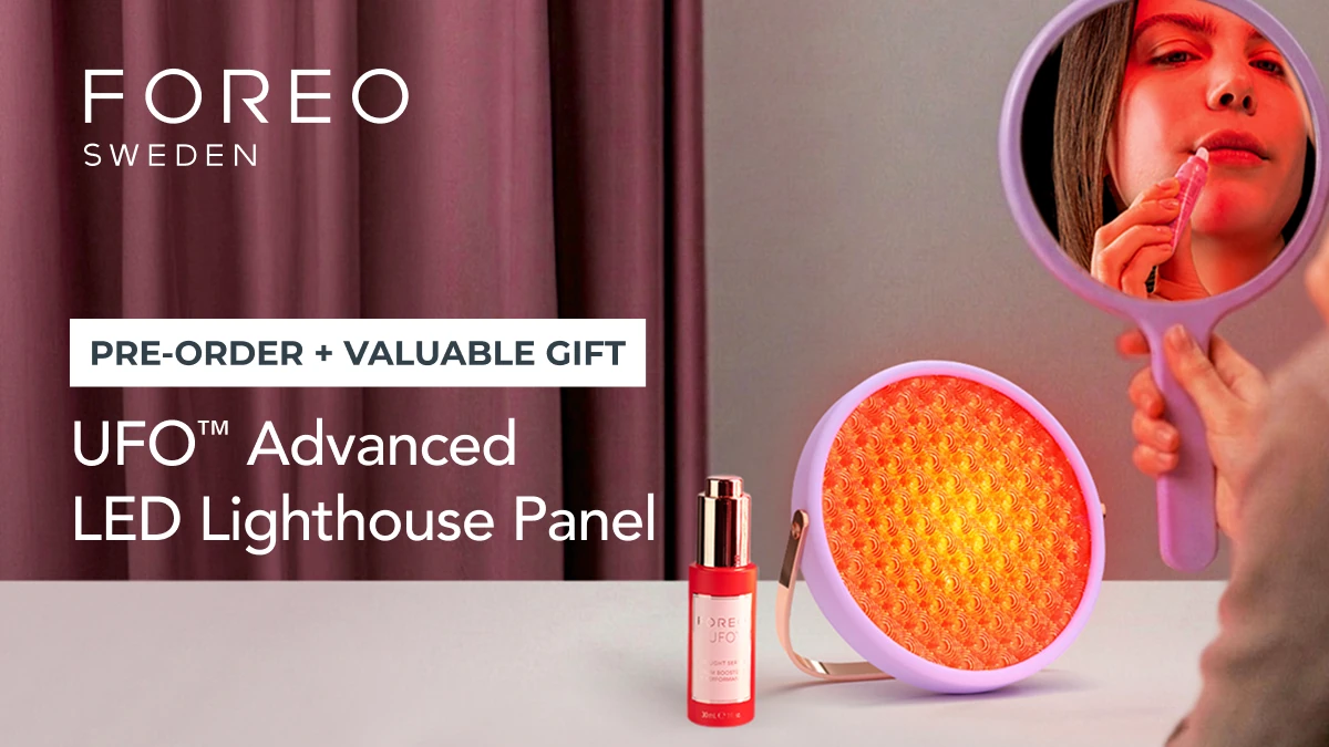 A woman using UFO Advanced LED lighthouse panel red light therapy