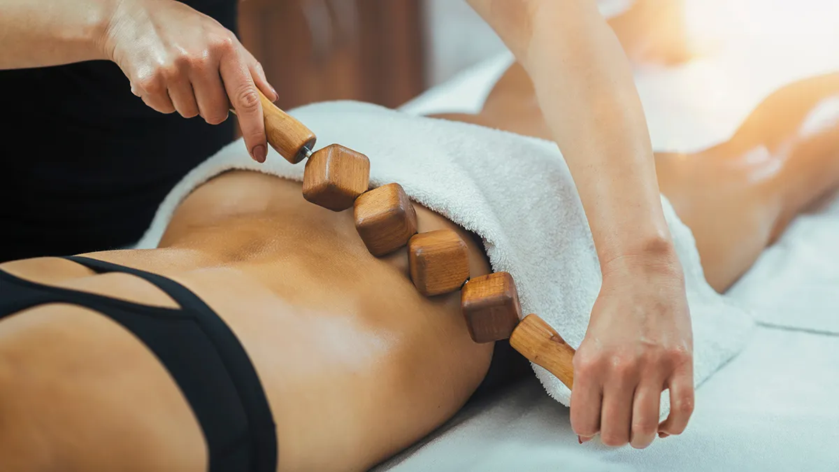 brazilian lymphatic drainage massage done witha wooden roller on the love handles