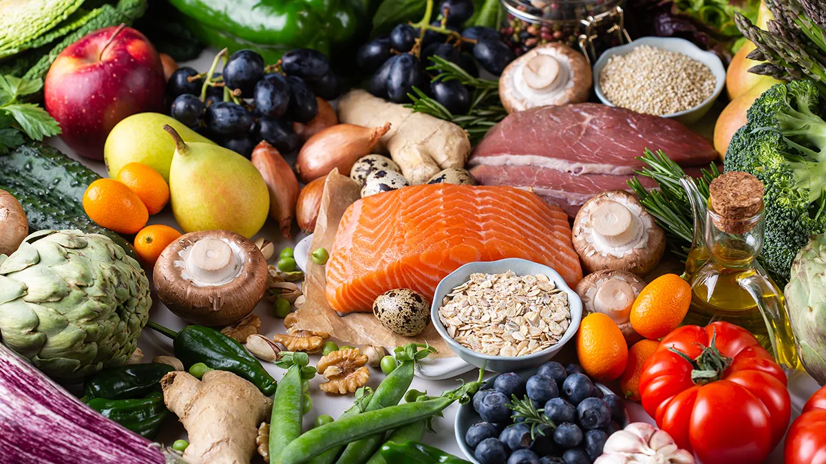 a table full of wonderful whole foods, fish, nuts, seeds, fruit, vegetables, and meat