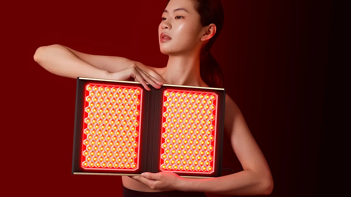 A naked model holding FAQ DUAL LED PANEL