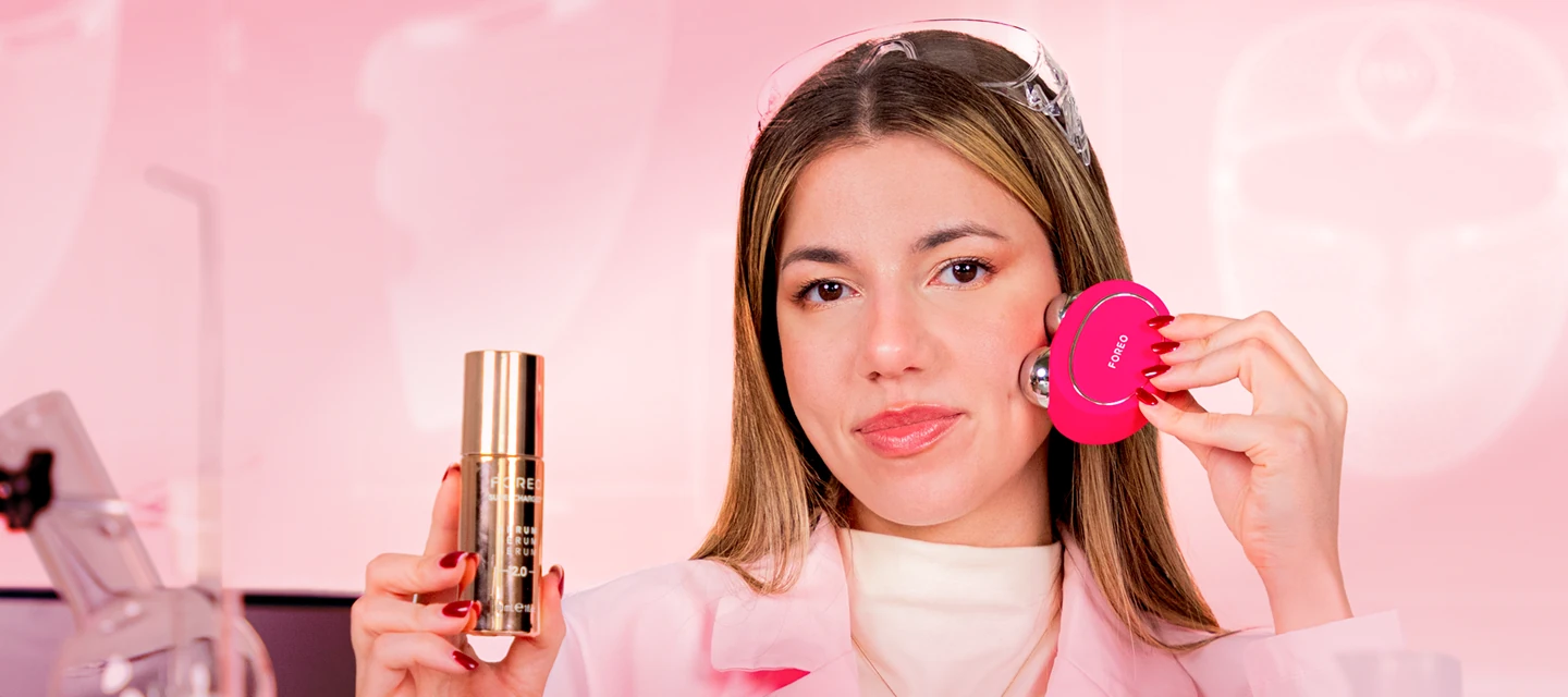 A woman using FOREO BEAR microcurrent device and a conductive serum