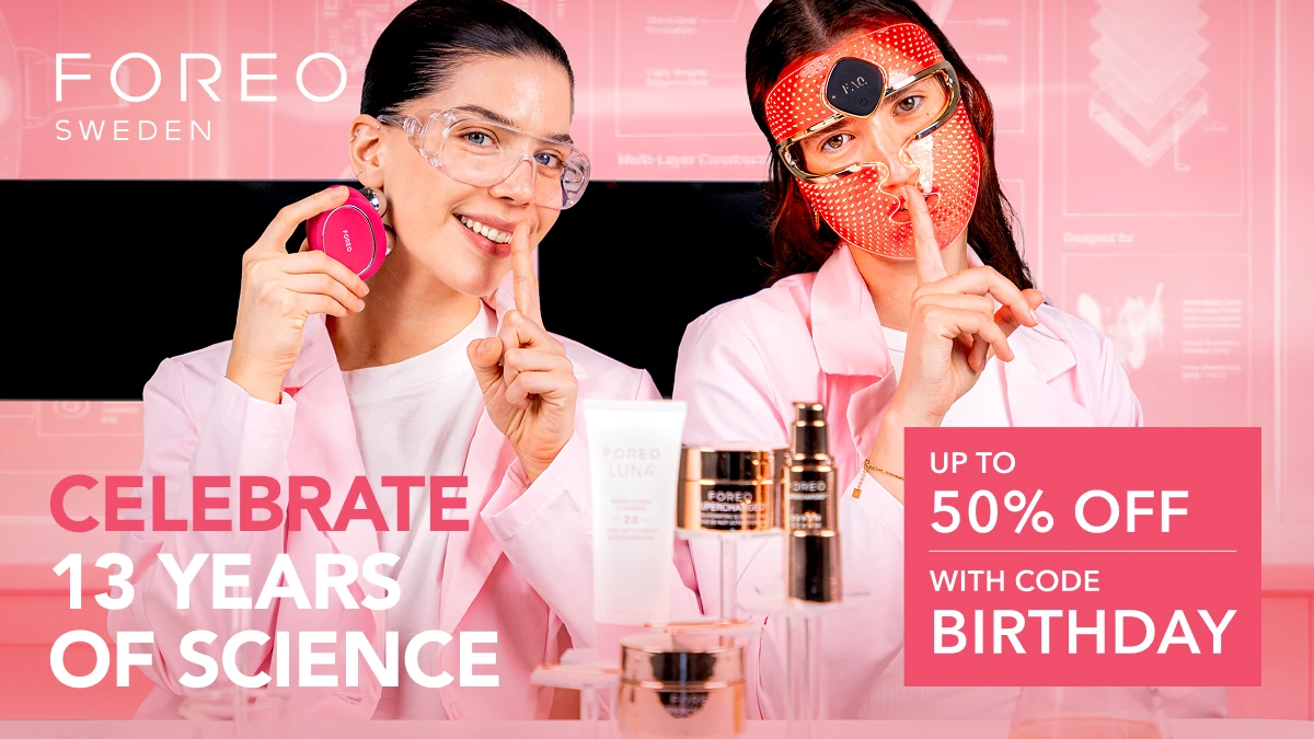 Two young women in pink lab coats enjoying the FOREO birthday skincare sale