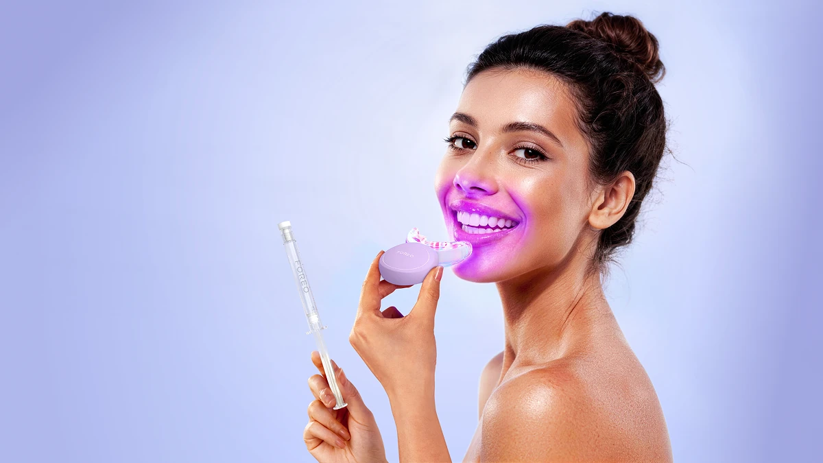 issa teeth whitening set used by a smiling woman with a bun