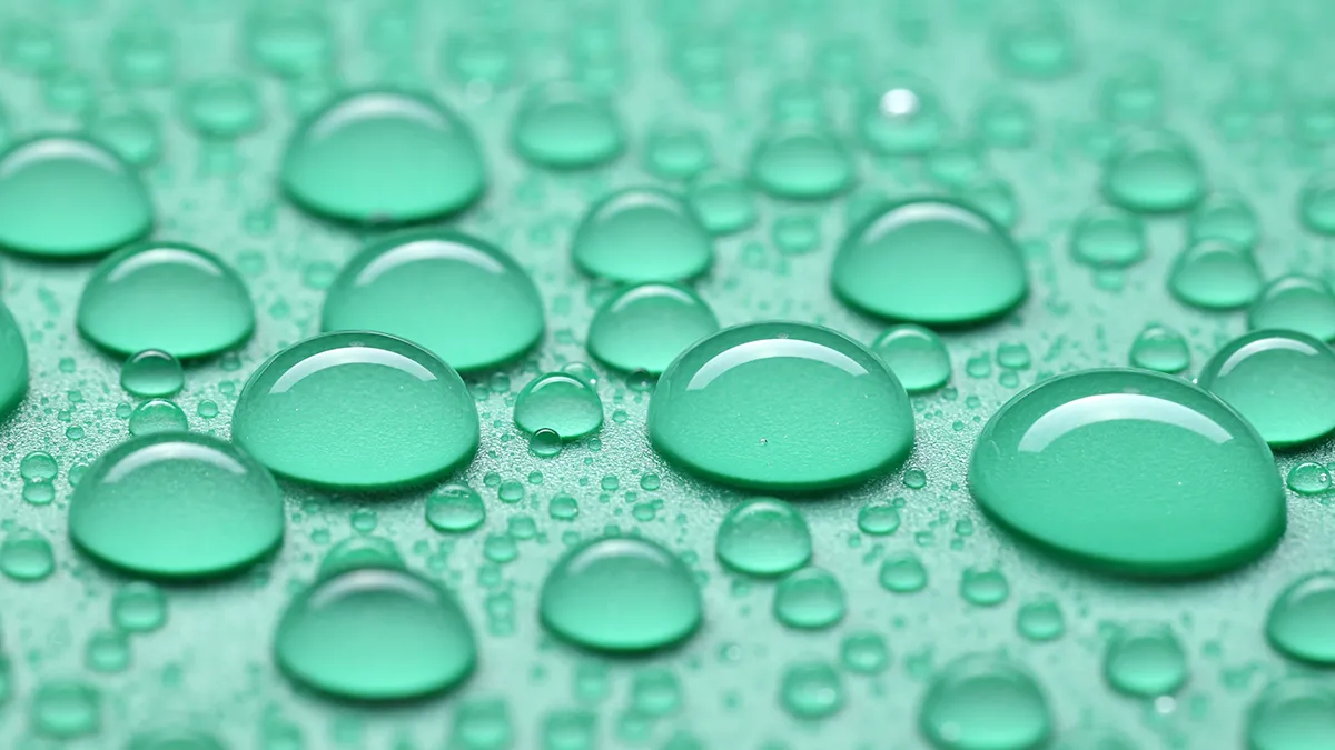 dropplets of water closeup on mint green background