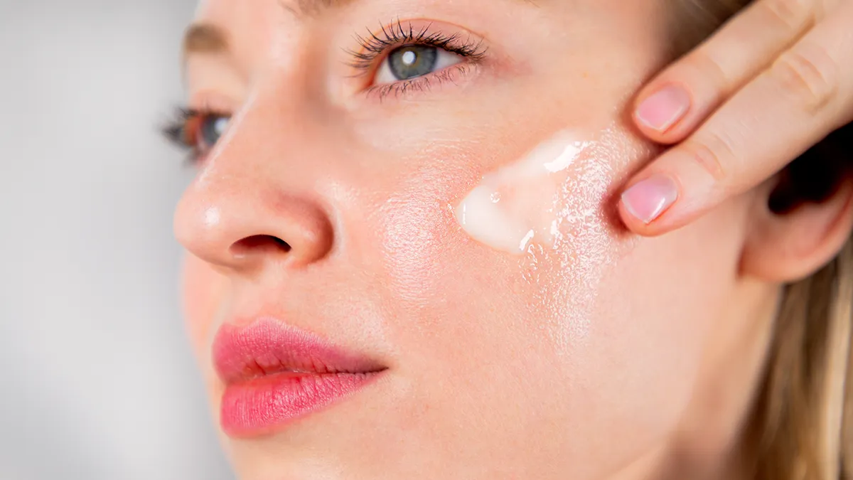 A woman using Face Cleansing Balm