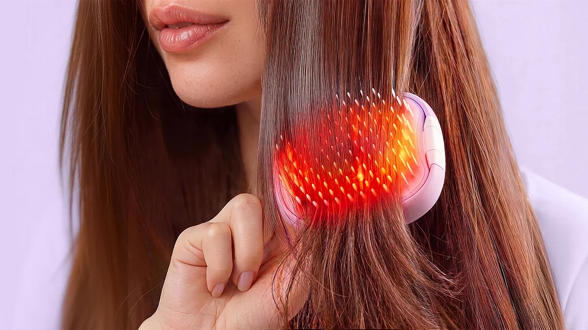 A woman using FLIP plus LED red light brush on her hair length