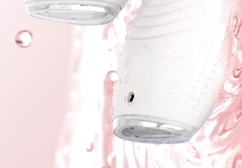 Back of the white FOREO LUNA 5 LED showing its ridged massage surface under falling water
