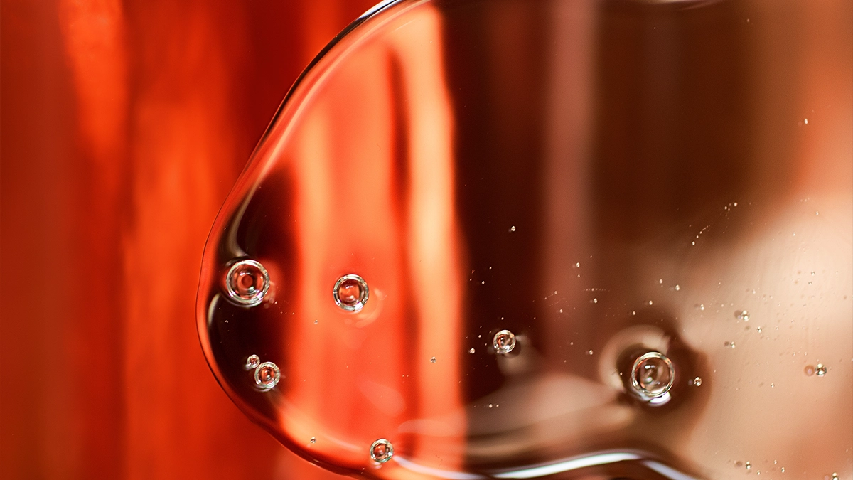 An abstract liquid on a burnt orange colored background