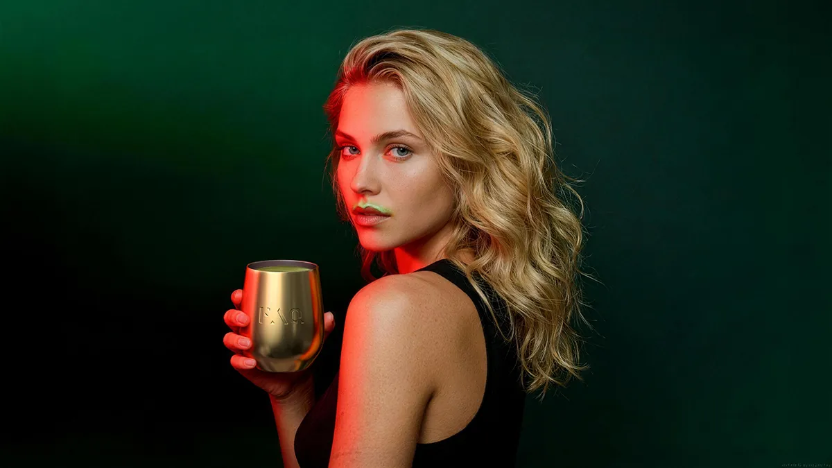 A gorgeous blond young woman with supergreens powder mustache after drinking it
