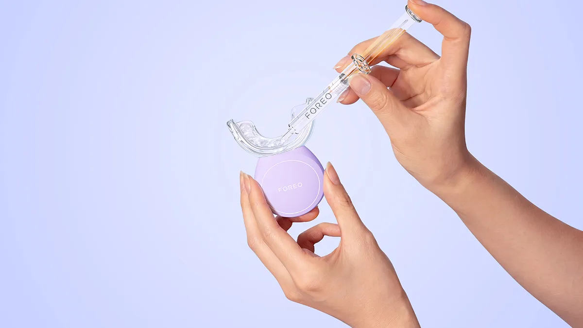 Putting the issa teeth bleaching gel on the FOREO issa LED teeth whitening device