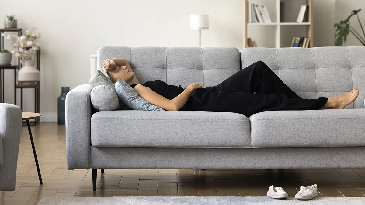 A woman in menopause tired on a couch