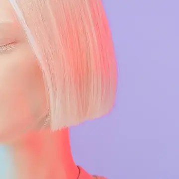 A beautiful albino girl with bob hair style and long lashes under neon light