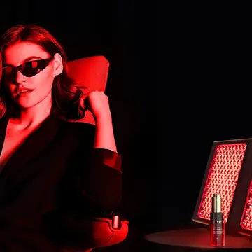 A modern woman in a dark room using FAQ dual LED light panel