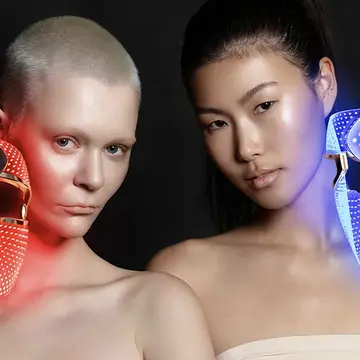 Two women with FAQ 202 plus LED light masks 