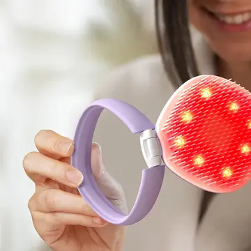 A woman opening FLIP™ play Advanced LED Light Hairbrush