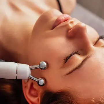 a woman getting a professional microcurrent treatment