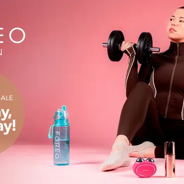  A beautiful young woman in sporty clothes excercising with a cake next to her 