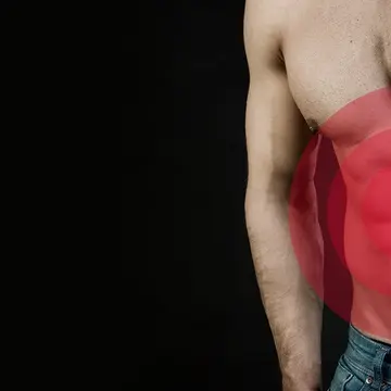 A torso of a muscular man with gut problems