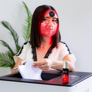 A woman using FAQ 202 mask in the office