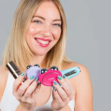 A woman holding multiple microcurrent toning devices on sale