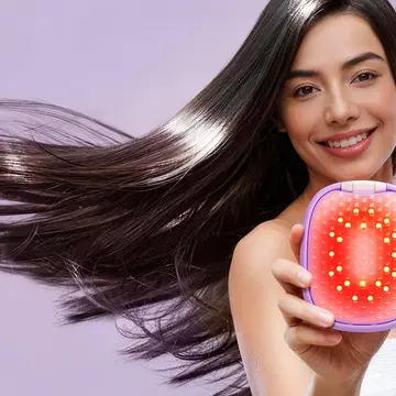 A woman with glossy hair in movement showing FLIP plus LED light hairbrush