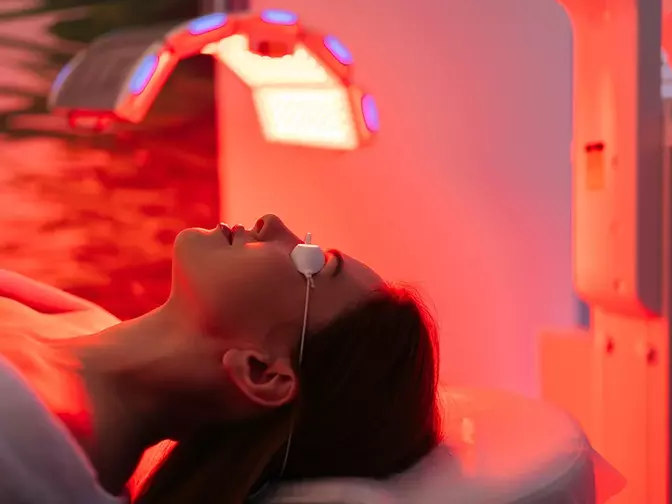 a woman enjoying a professional red light therapy in a salon