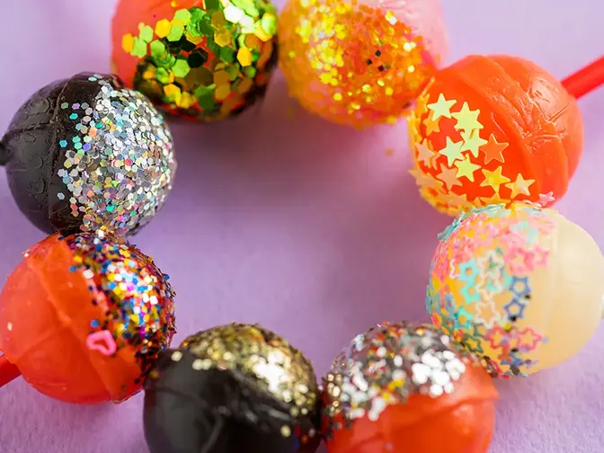 Colorful lollypops in a circle with glitter on them 