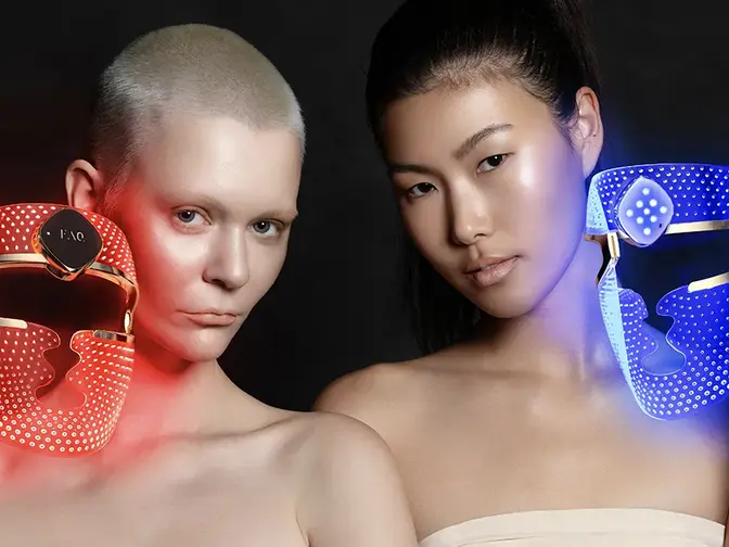 Two women with FAQ 202 plus LED light masks 