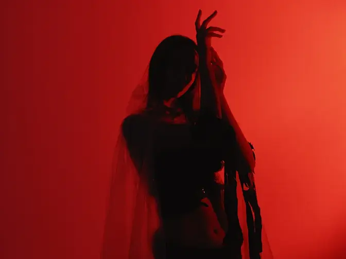 A woman dancing in red lights