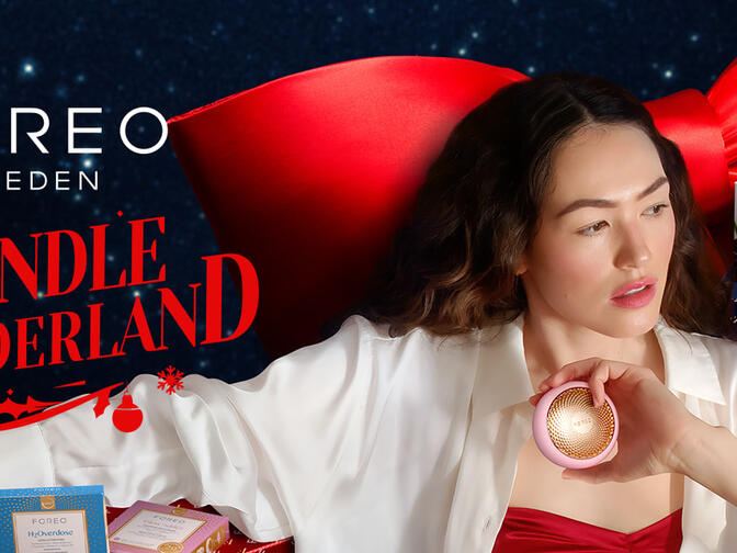 A woman using FOREO devices in a holiday setting