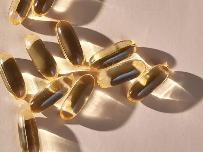Translucent supplement capsules glistening in the light 