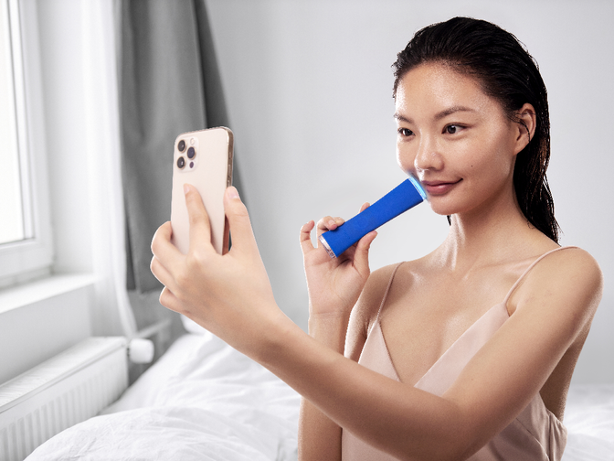 A woman using ESPADA FOREO for acne