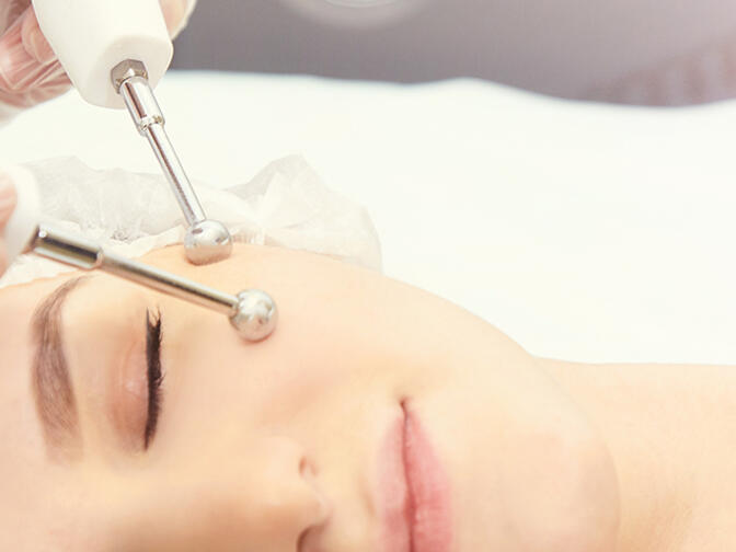 Woman receiving microcurrent therapy