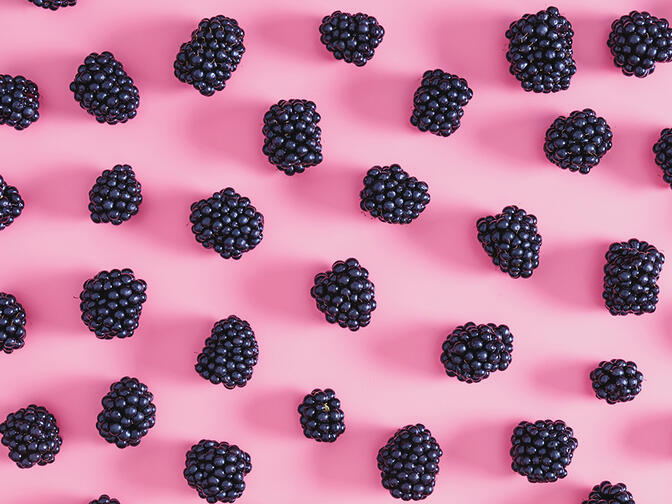 Blackberries on a pink surface