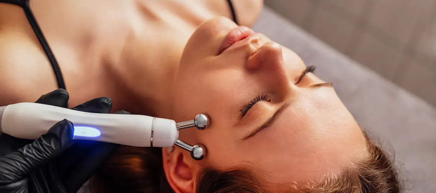 a woman getting a professional microcurrent treatment