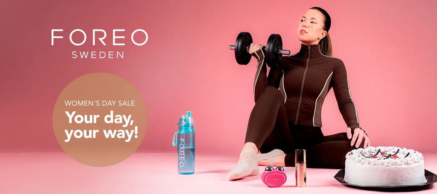  A beautiful young woman in sporty clothes excercising with a cake next to her 