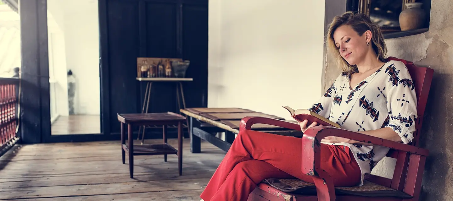 A woman reading a book and enjoying her day