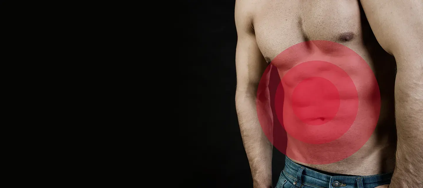 A torso of a muscular man with gut problems